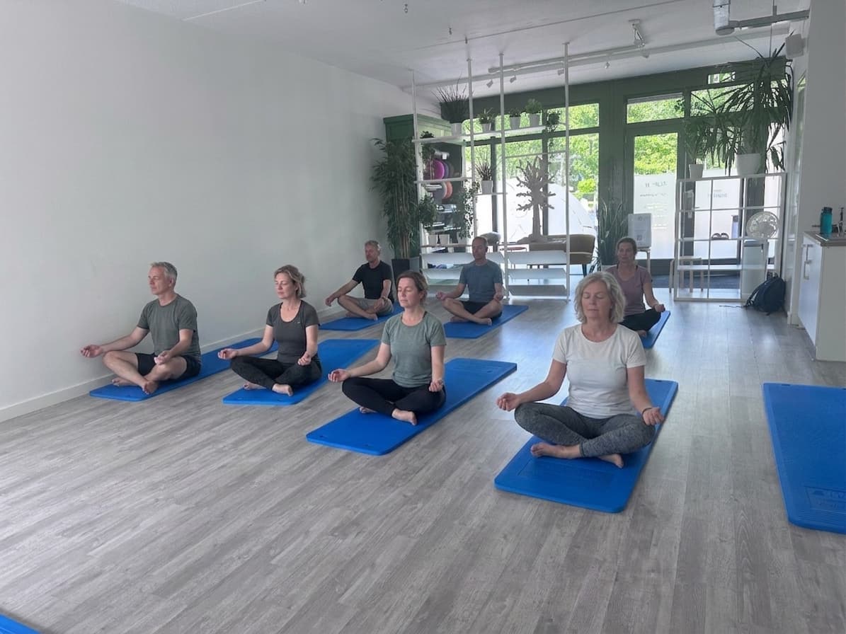Adults sitting quietly on their mats